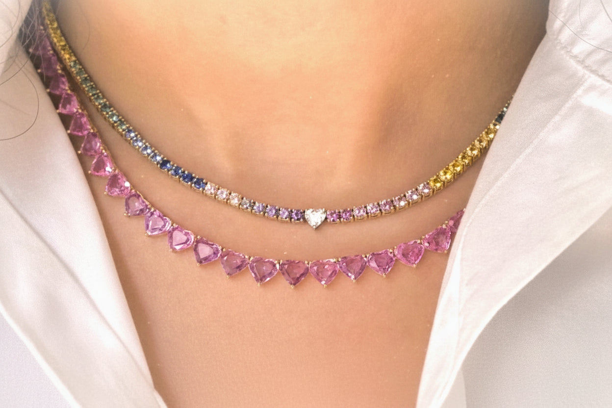 Necklace with pink heart-shaped gemstones worn by a person